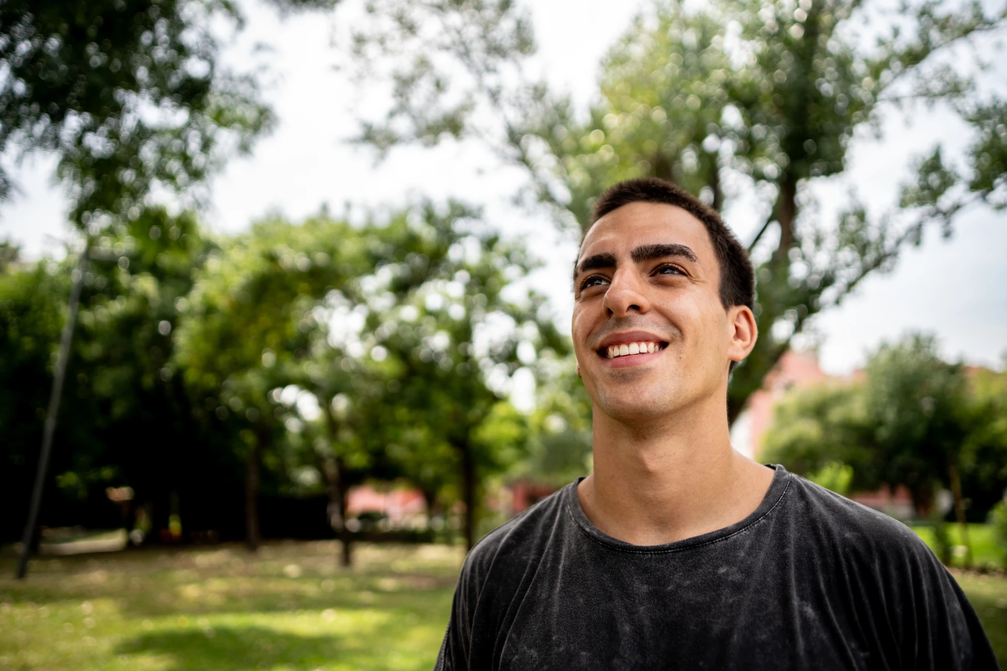 Happy man standing outside looking off into the distance